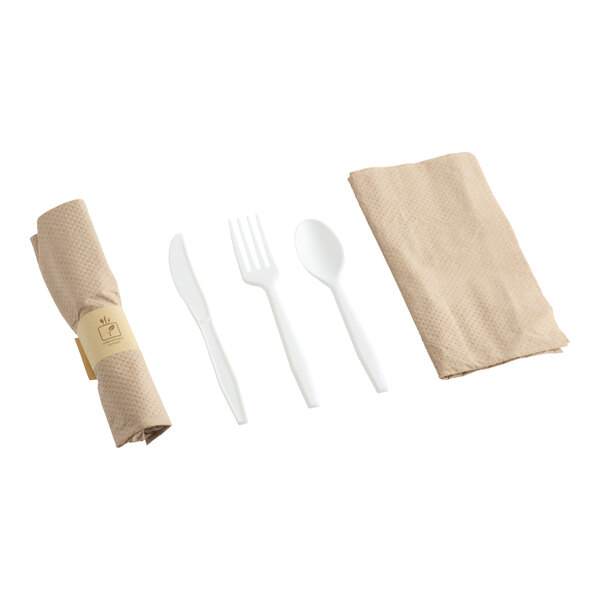 A pre-rolled napkin and white plastic flatware kit including a knife, fork, spoon, and napkin.
