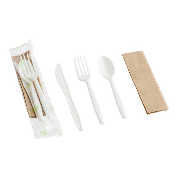 A set of individually wrapped white plastic cutlery including a knife, fork, spoon, and a brown napkin.