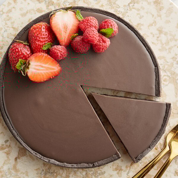A chocolate pie with a slice missing and a piece of Guittard Old Dutch milk chocolate on top.