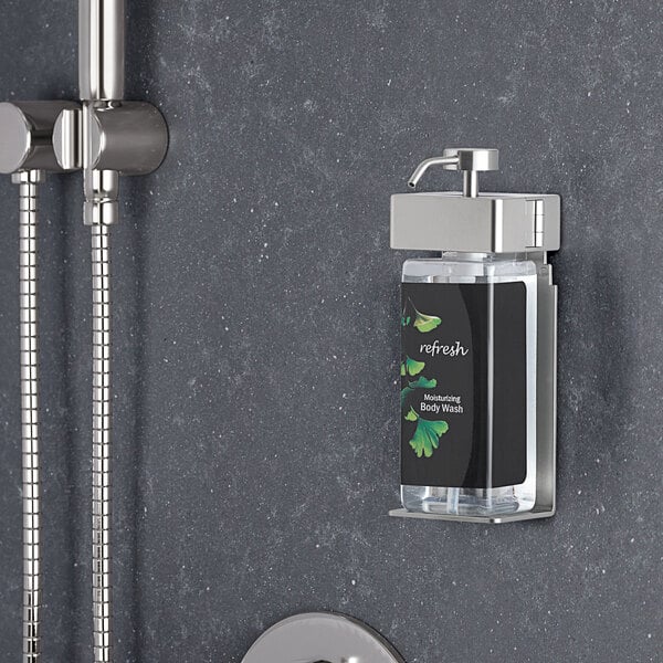 A wall-mounted Dispenser Amenities SOLera shower soap dispenser with a rectangular bottle and Ginkgo label.