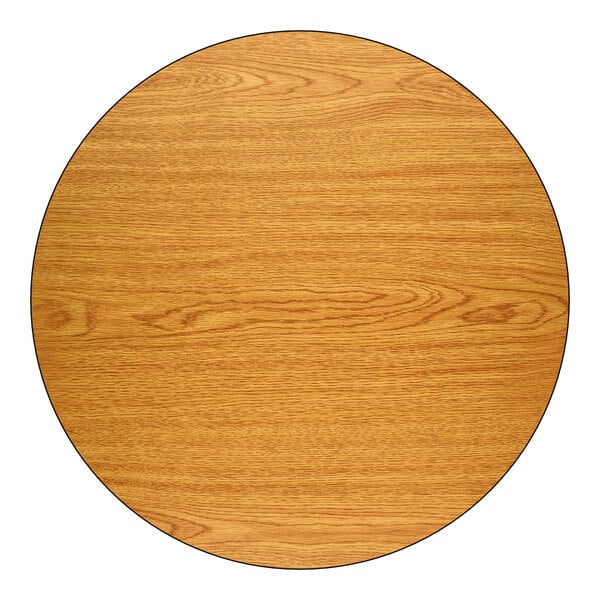 A round, 36-inch laminated table top with a reversible walnut and oak finish.