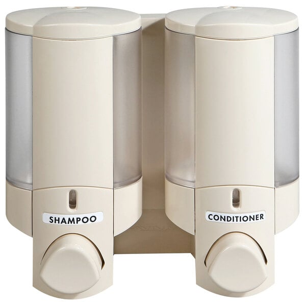 A white Dispenser Amenities Aviva wall mounted soap dispenser with two translucent bottles of vanilla shampoo inside.