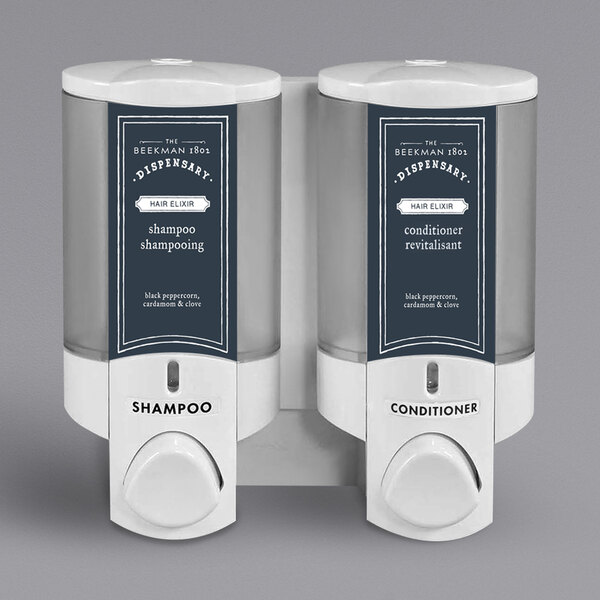 A white Dispenser Amenities Aviva 2-chamber wall mounted soap dispenser with Beekman logo.