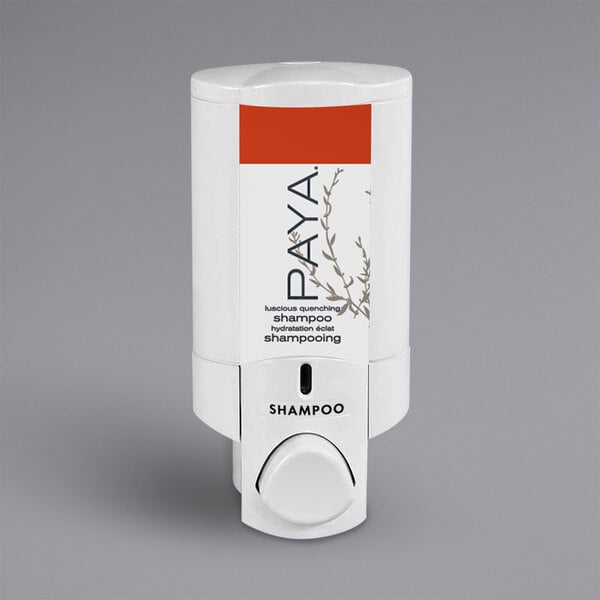 A white plastic Dispenser Amenities wall-mounted shower dispenser with a red Paya label on a bottle inside.