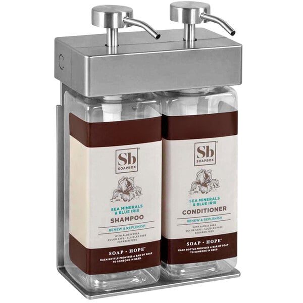 A white and brown Dispenser Amenities wall mounted 2-chamber shower dispenser with rectangular bottles labeled shampoo and conditioner.