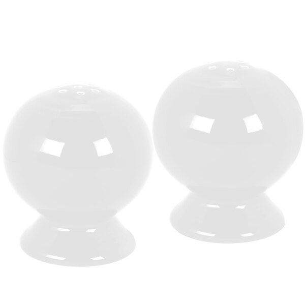 A pair of white Fiesta salt and pepper shakers.