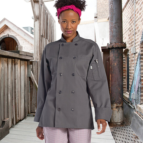 A woman wearing a Uncommon Chef Orleans slate long sleeve chef coat.