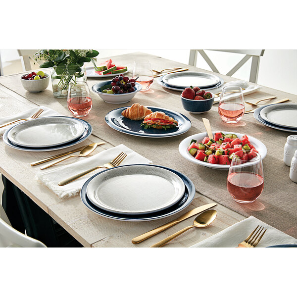 A table set with American Metalcraft Jane Casual melamine plates, bowls, and forks.
