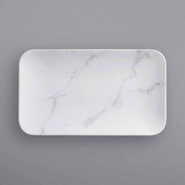 a white rectangular plate with marble pattern