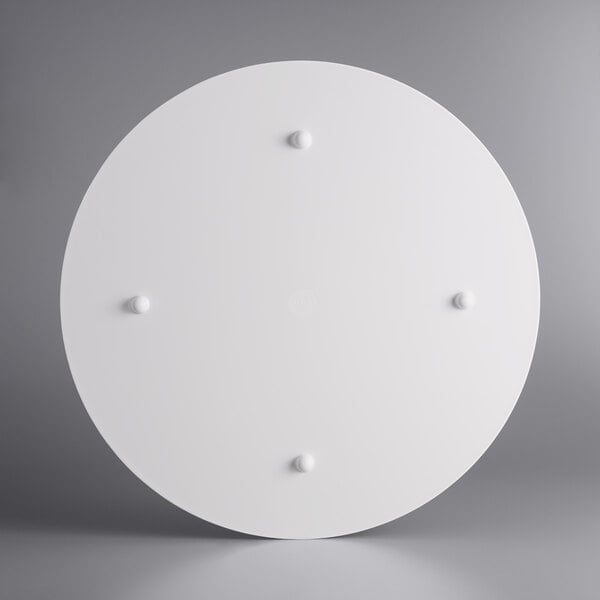 A white circular American Metalcraft faux reclaimed wood melamine serving board with four pegs.