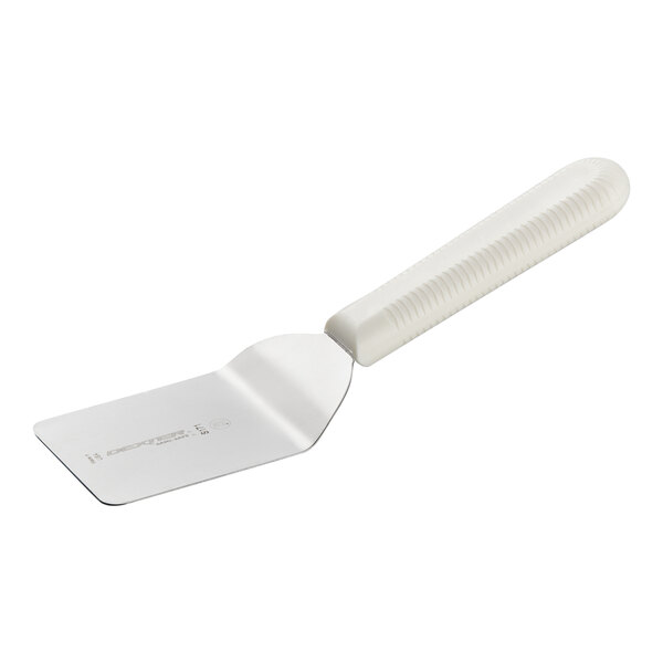 A small metal spatula with a white textured plastic handle.