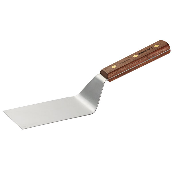 A Dexter-Russell metal hamburger turner with a wooden handle.