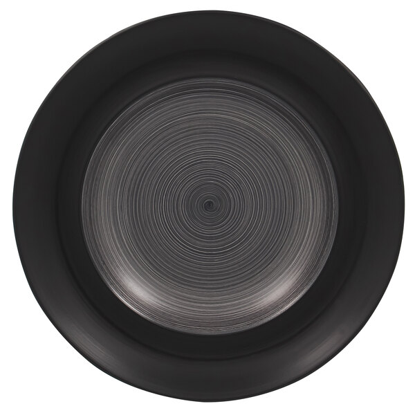A circular black RAK Porcelain plate with a spiral pattern on the rim.