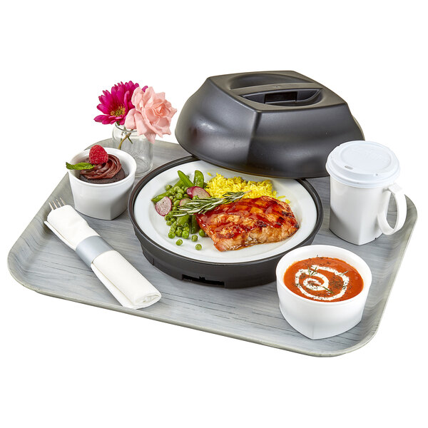 A tray with a white Cambro bowl of soup, a black plate with a lid, and a white coffee cup with a black lid on it.