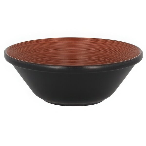 A brown and black stackable porcelain bowl with brown stripes on the counter.