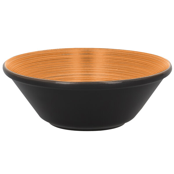 A black RAK Porcelain bowl with a cedar and orange rim.