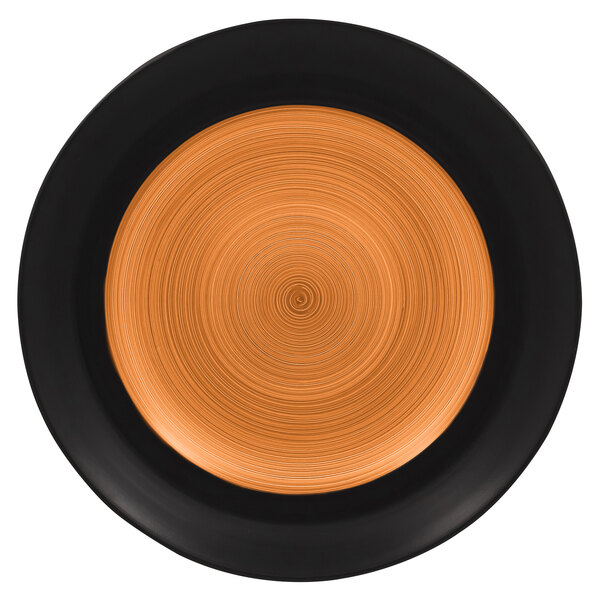 A white porcelain plate with a black and orange swirl design on the rim.