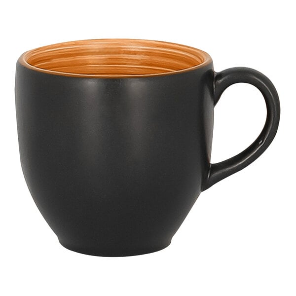 A close up of a black and orange RAK Porcelain Trinidad cup with a handle.