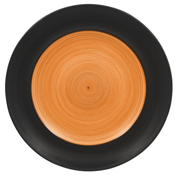 A close up of a RAK Porcelain Trinidad wide rim plate with a circular design in cedar and black.