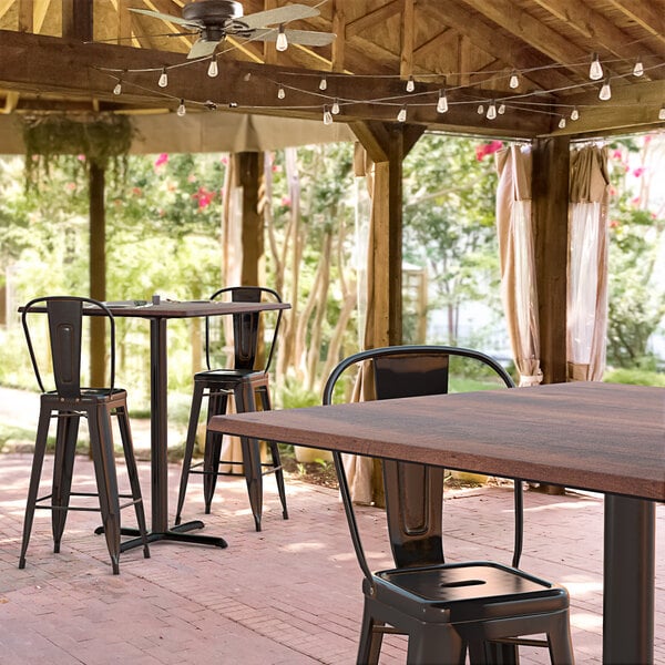 a table with chairs on a brick surface