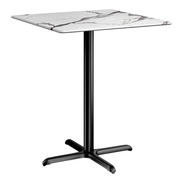 A square bar height table with a smooth white marble-like top and a black cross base plate.