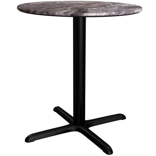 A round Lancaster Table with a marble top and black cross base.