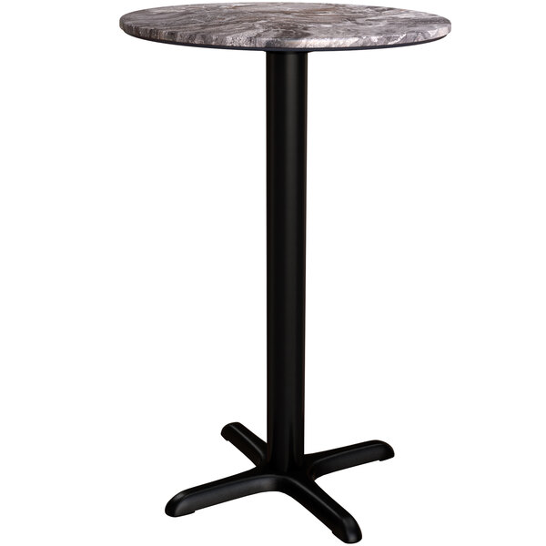 A round Lancaster Table & Seating counter height table with a black cross base.