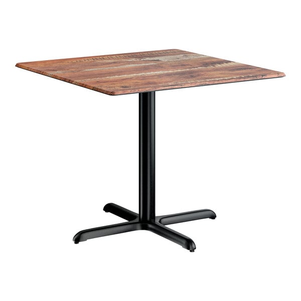 A square standard height table with a textured Yukon oak finish top and a black cross base plate.