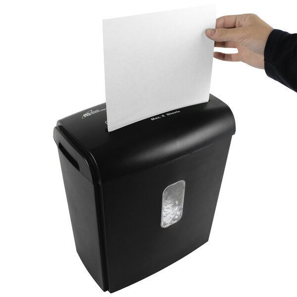 A hand putting a white sheet of paper into a black Royal Sovereign cross-cut shredder.