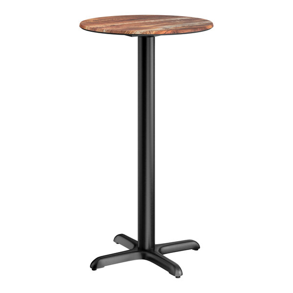 A round bar height table with a textured Yukon oak finish top and a black cross base plate.