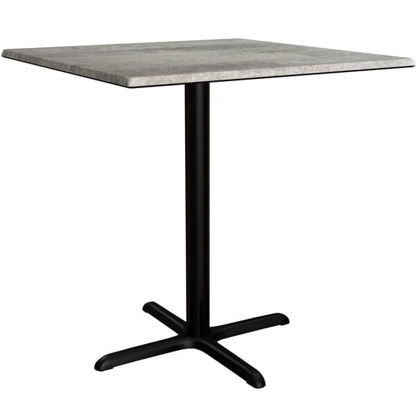 A Lancaster Table & Seating Excalibur square counter height table with a black base and a textured gray top.