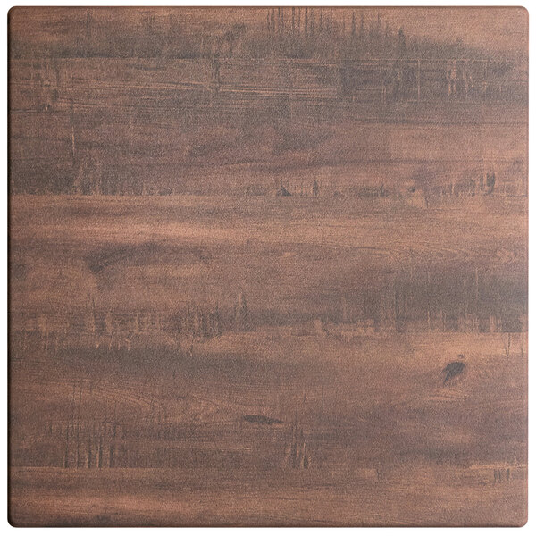 A close up of a Lancaster Table & Seating square wooden table top with a textured walnut finish.