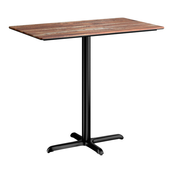 A rectangular bar height table with a textured Yukon oak finish top and a black cross base plate.