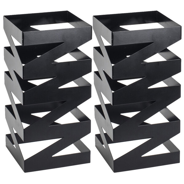 A pair of black metal zigzag display risers.