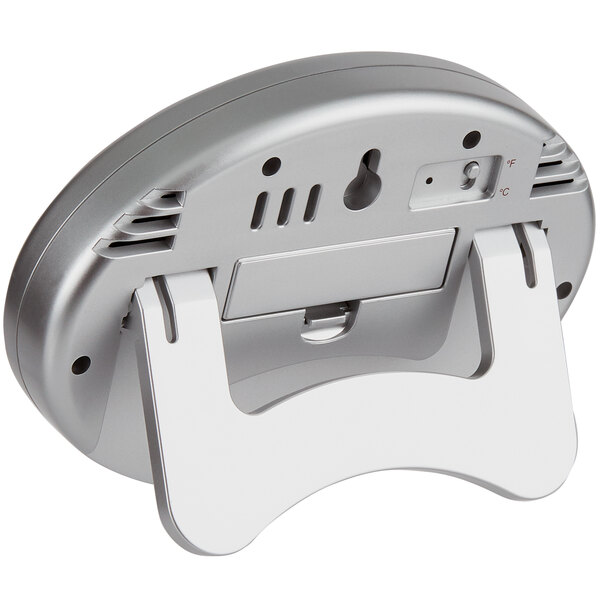 A silver and white Cooper-Atkins digital wall thermometer with remote.