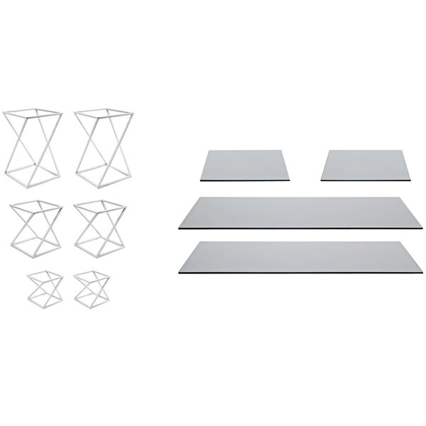 A white metal Front of the House Twist riser set with smoke glass boards on a table.