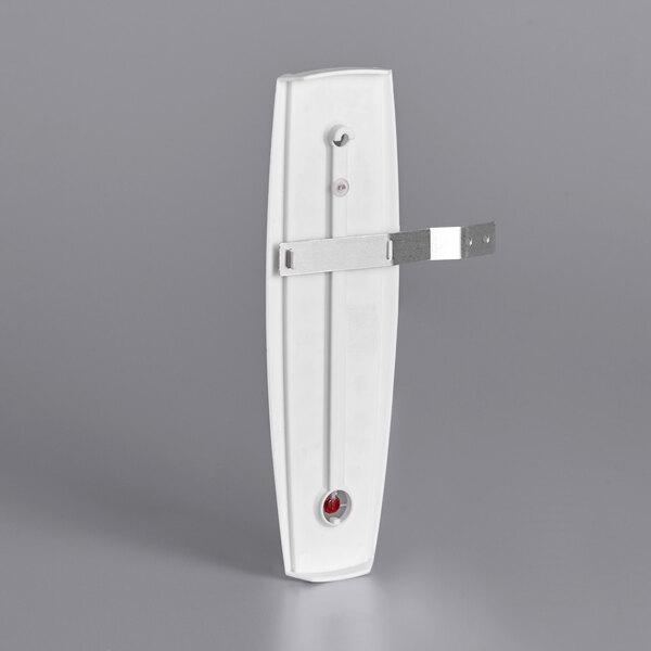 A white rectangular outdoor thermometer with a metal frame and red temperature numbers.