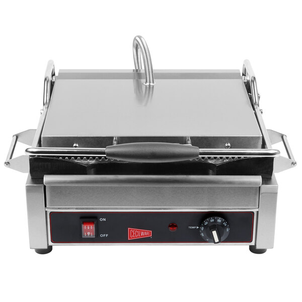 A close-up of a Cecilware panini grill with grooved surfaces and a red handle.