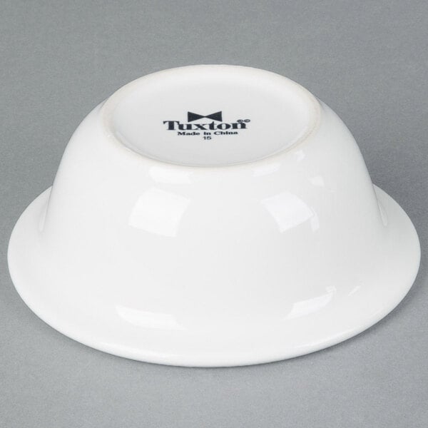 A white Tuxton china bowl with black text that says "Tuxton"