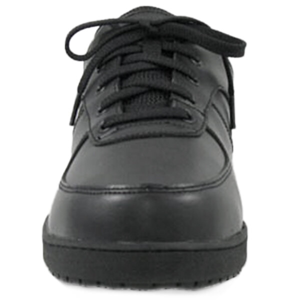 A close up of a black Genuine Grip leather shoe with laces.