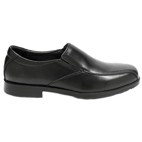 A black Genuine Grip men's slip-on dress shoe with a rubber sole.