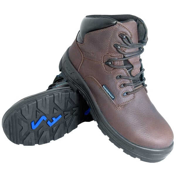 A pair of Genuine Grip brown leather work boots with a composite toe and blue laces.