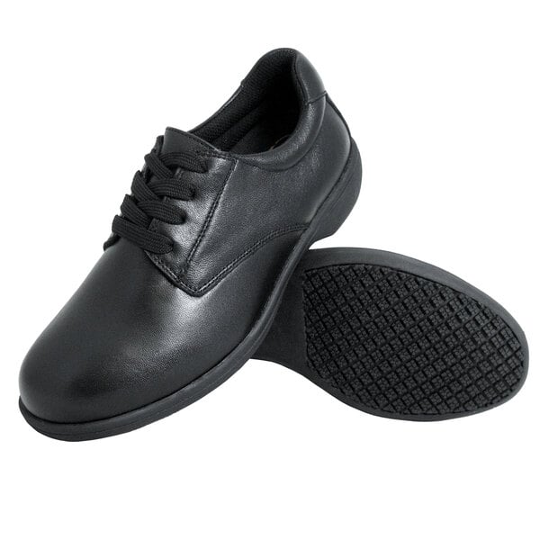 A pair of black lace-up shoes with a smooth finish and textured non-slip soles.