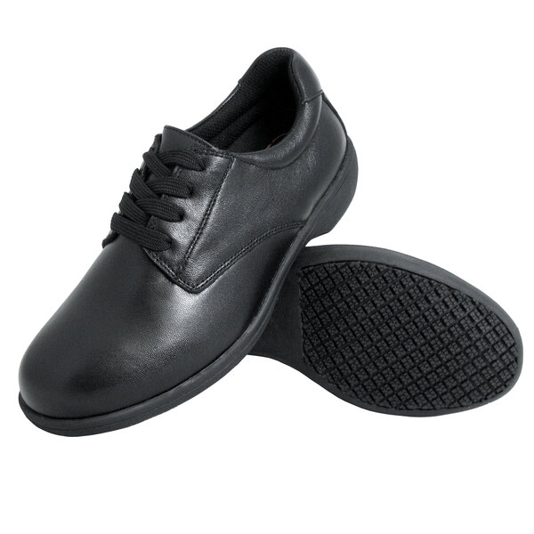 A black leather Genuine Grip women's shoe with laces and rubber soles.