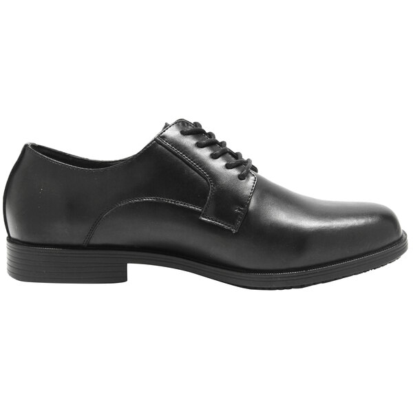 A black Genuine Grip men's oxford dress shoe with laces and a rubber sole.