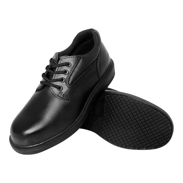 A pair of men's black leather Genuine Grip oxford shoes with laces and a black rubber sole.