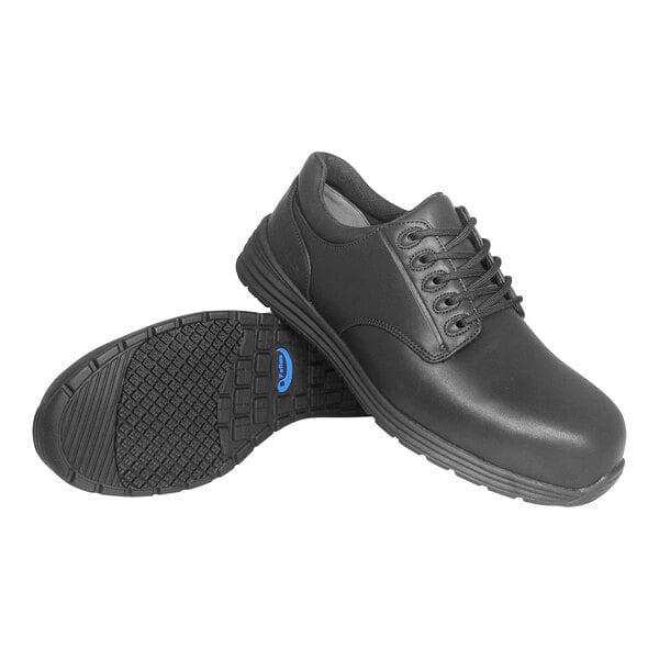 A pair of black Genuine Grip composite toe shoes with laces and rubber soles.