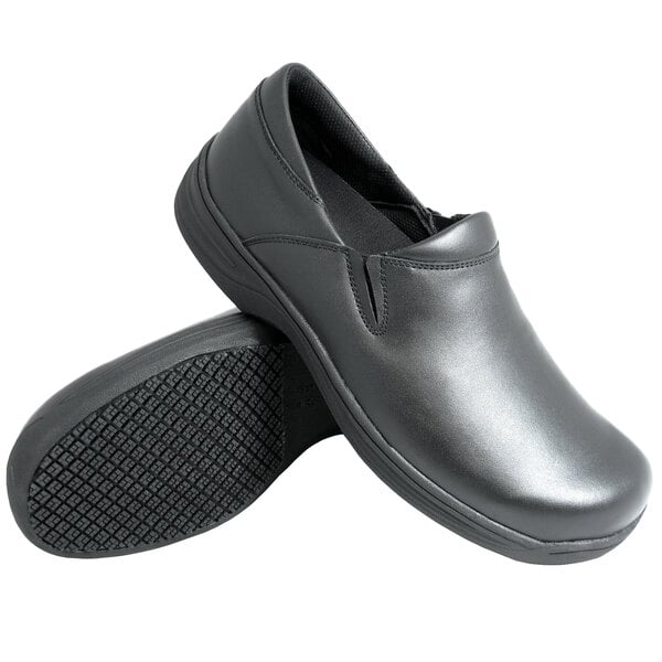 A pair of black slip-on shoes with a smooth finish and textured non-slip soles.