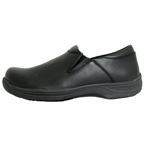 A black slip-on shoe with a smooth finish, elastic side panels, and a thick, textured sole.