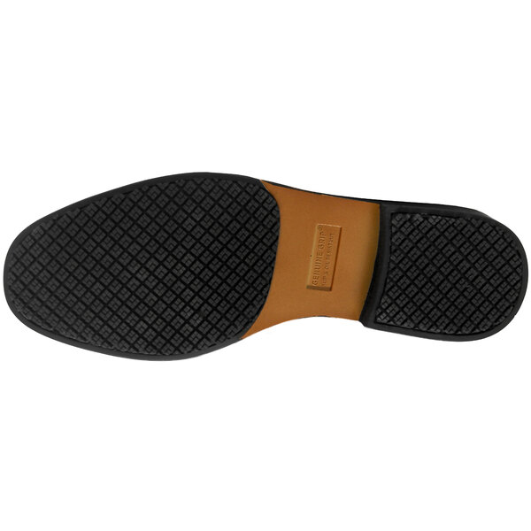 The brown and black sole of a Genuine Grip men's dress shoe.